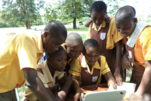 Children in Ghana learning on a computer.