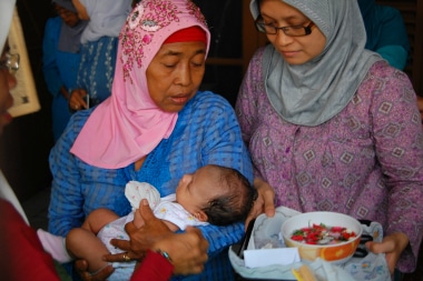 Mother, child and volunteer in Indonesia.