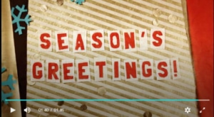 Snapshot of S.I.'s holiday video saying Season's Greetings!