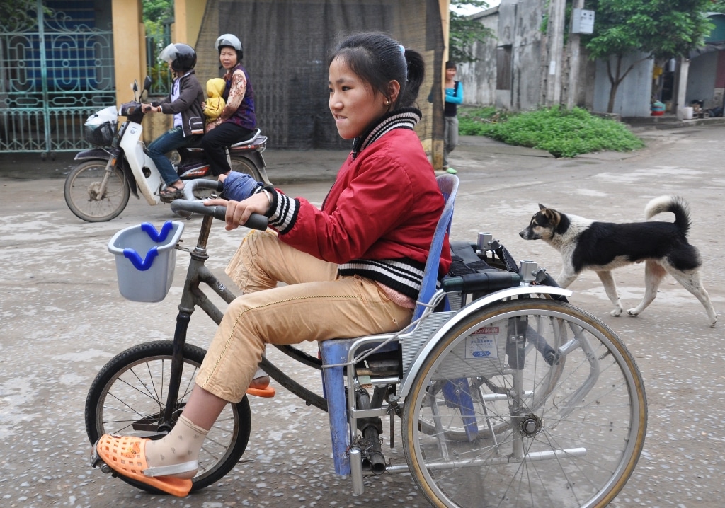 Person on a wheelchair bicycle in Vietnam.