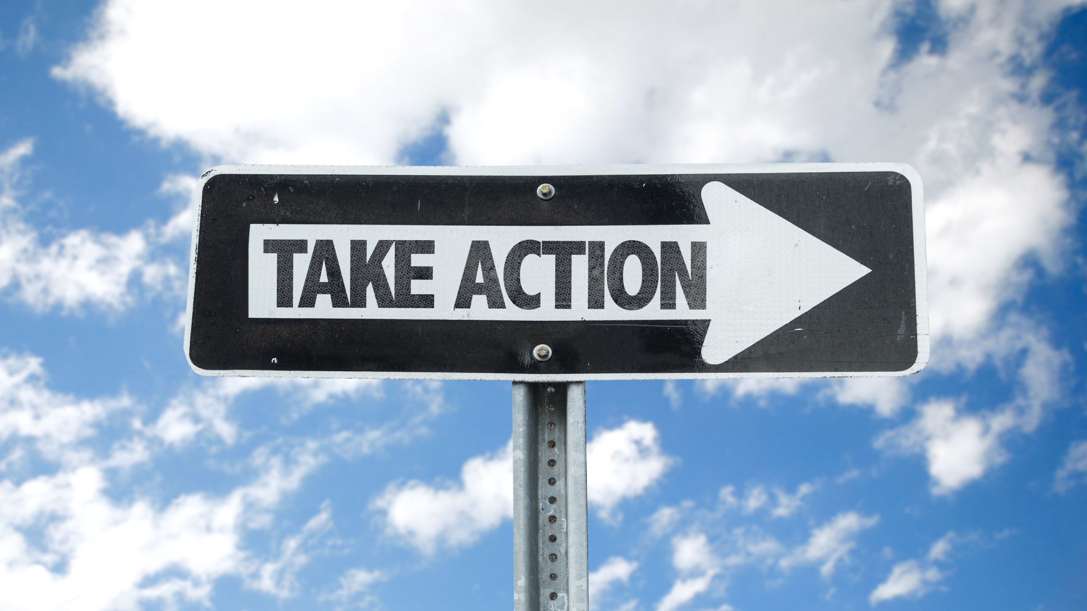 Take Action direction sign with sky background