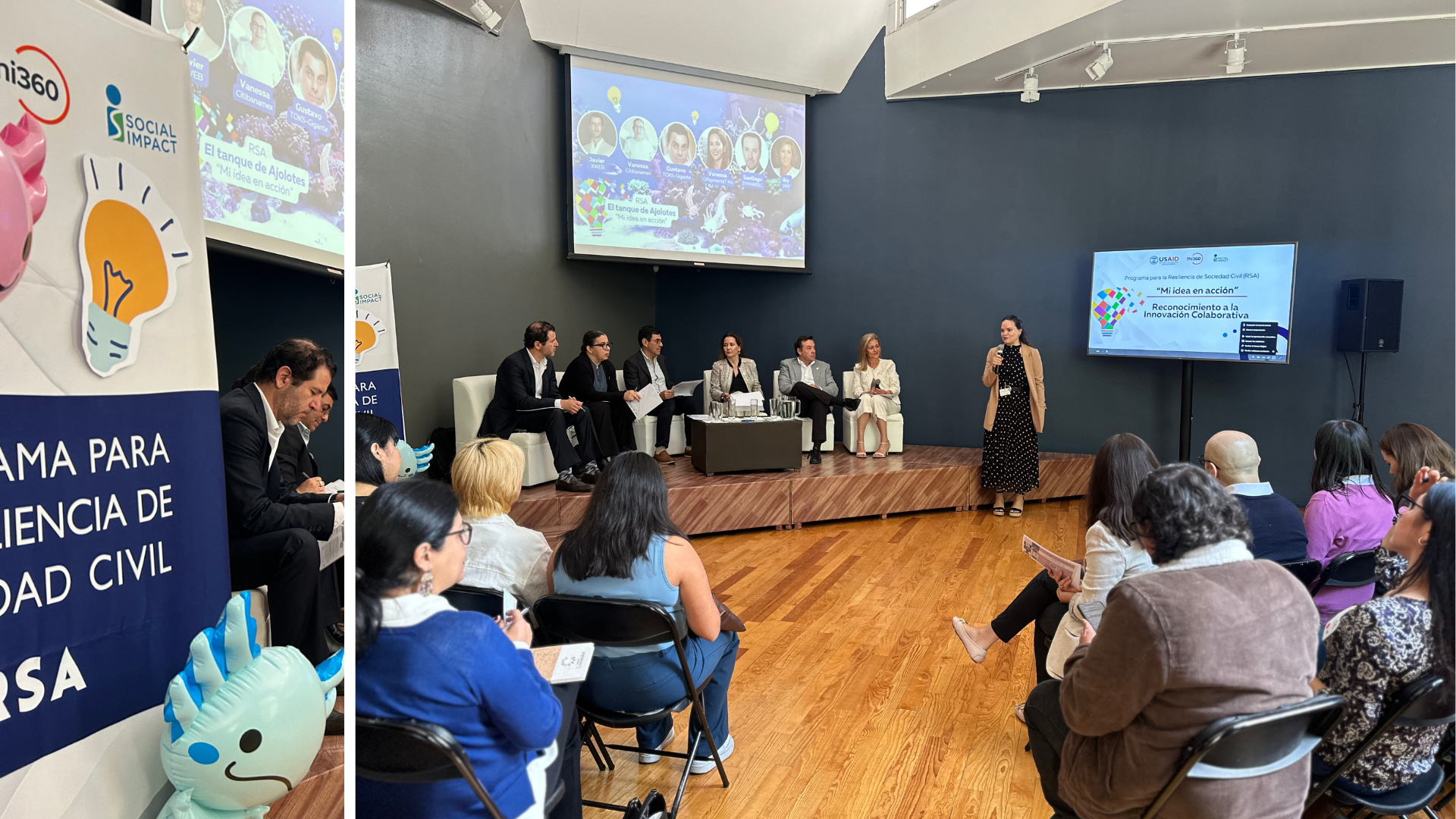 Panel presentation on a small stage in front of an audience sitting on foldout chairs.